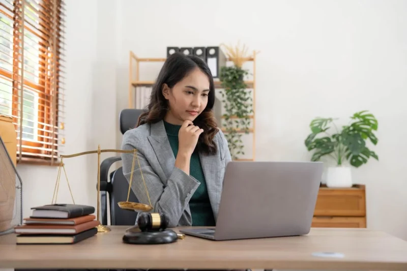 A consultant taking a phone call while holding a tablet at a desk
